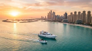 Things to do on water in Dubai — yacht and boat cruising past the Dubai Marina skyline at sunset